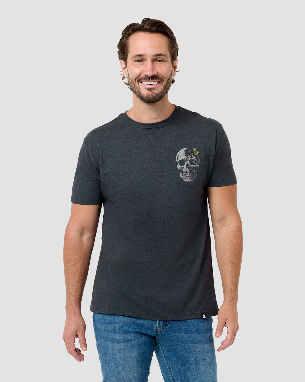 Man wearing the INTO THE AM Split Nature graphic tee in charcoal, a hand-drawn landscape print split across the chest