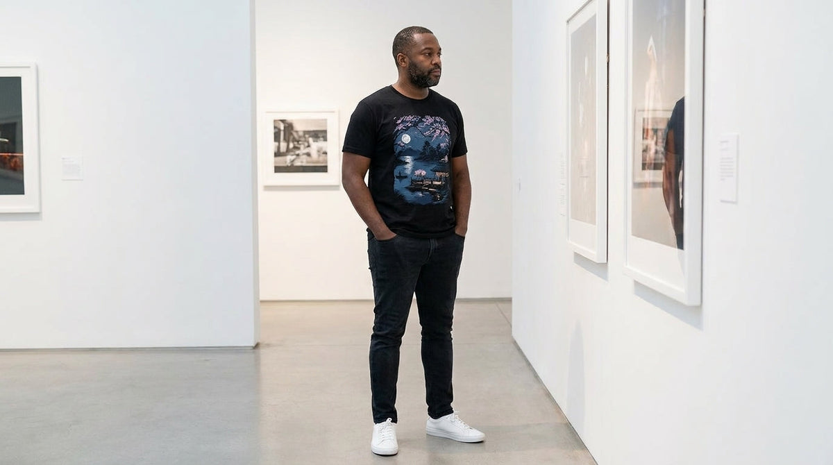 Man wearing a white INTO THE AM graphic t-shirt outdoors, best graphic tees without logos: 2026